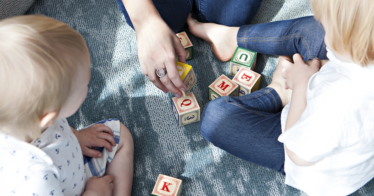 Young children playing and learning with letter blocks, inclusive early education